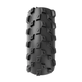 Black off-road tire with prominent tread pattern on a white background