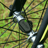 Bryton bike computer attached to a bicycle wheel with grass in the background
