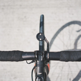 Close-up of a bicycle handlebar with a blurred background