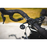 Close-up of a bicycle handlebar with control buttons on a blurred background
