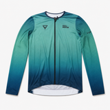 A long-sleeve cycling jersey with a teal and blue gradient design, featuring a black zipper, a triangular logo on the left chest, and 'SKULL MOUNTON' printed on the right chest, displayed on a light gray background.