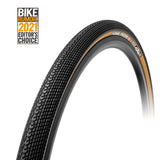 A black TUFO Speedero GRAVEL Tyre with a textured tread pattern, highlighted by a tan sidewall and a Bike Riding Editor's Choice label.