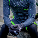A person wearing Tineli Thermal Winter Gloves in black with green accents on the sleeves.