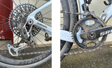 Close-up of a bicycle's gear system with SRAM components on a concrete surface.