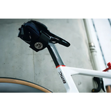 Close-up of a bicycle seat with BMC branding on a blurred background