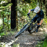 Person riding a mountain bike through a forest
