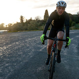 Cyclist riding on a road with a scenic background