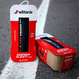 Vittoria bicycle tire packaging, featuring the Corsa N.EXT tire model in red and white with product information.